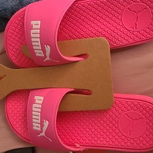 Bright pink Puma slides